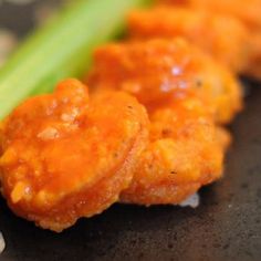 some kind of food that is sitting on a black plate with white dots around it