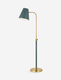 a brass and blue floor lamp with a black shade on the top, in front of a white background