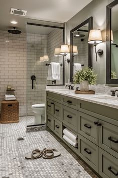 a large bathroom with two sinks, mirrors and towels on the floor in front of it