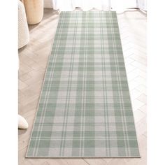 a green and white plaid rug on the floor