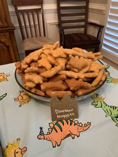 there is a plate full of dog biscuits on the table with a name tag in front of it