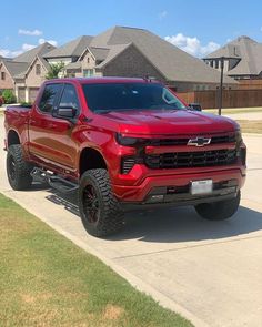 a red truck parked in front of a house