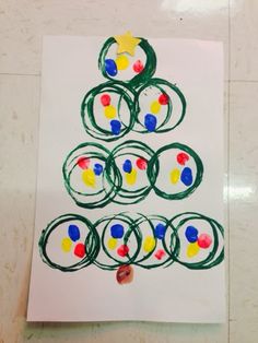 a child's drawing of a christmas tree made with circles and colored pencils