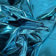 an image of shiny blue material that looks like metal