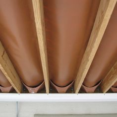 a close up view of some wood and leather coverings on a building's roof