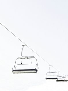 a ski lift with two people on it in the snow