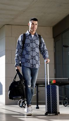 a man walking with his luggage in hand