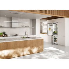 a kitchen with an island, sink and refrigerator