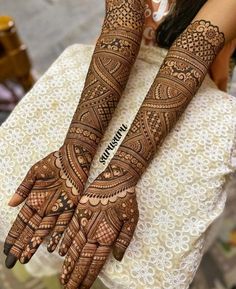 the hands and feet of a woman with henna tattoos on their arms are shown