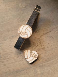 two wooden heart shaped volleyballs on a wood floor