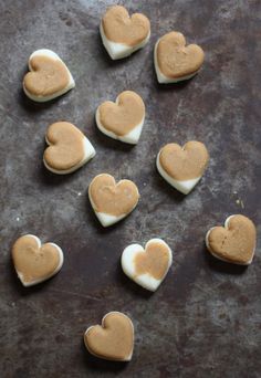 heart shaped cookies are arranged on a baking sheet