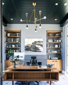 a home office with built - in shelving and desk