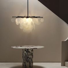 a marble table and chandelier in a room