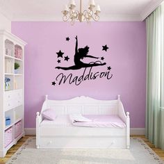 a bedroom with a purple wall and a ballet quote on the wall, above a white day bed