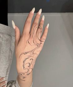 a woman's hand with a tattoo on it