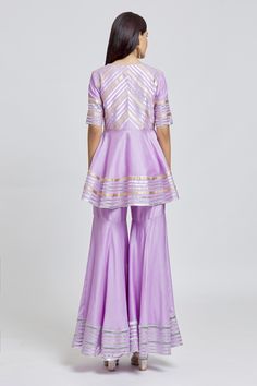 Purple peplum kurta with gota embroidery in striped pattern. Paired with a gharara and dupatta.
Components: 3
Pattern: Embroidered
Type Of Work: Gota
Neckline: Round V
Sleeve Type: Elbow
Fabric: Kurta and Gharara: Silk Chanderi, Dupatta: Organza
Color: Purple
Other Details: 
Gota striped embroidery
Occasion: Mehendi and Haldi - Aza Fashions Festive Anarkali Kurta With Peplum Style, Designer Peplum Palazzo Set For Diwali, Anarkali Peplum Kurta For Festive Occasions, Diwali Designer Peplum Palazzo Set, Festive Navratri Kurta With Peplum Shape, Eid Resham Embroidery Peplum Palazzo Set, Navratri Festive Peplum Kurta, Festive Navratri Peplum Kurta, Festive Peplum Kurta For Festivals