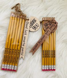 four pencils with wooden tags on them