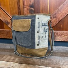 Up-Cycled From Canvas, Denim, And Leather Fully Lined Interior With 2 Slip Pockets And One Zip Pocket Back Exterior Has A Zip Pocket Front Exterior Has A Slip Pocket Under Leather Flap Dimensions: 12" H X 13.5" W; Shoulder, 23.5" Adjustable This Bag Is Made Of Up-Cycled Military Tents. Slight Variations, Including Stitch Marks And Minor Staining On The Canvas Or Leather, Are Possible. Each Bag Is Handcrafted With The Spirit Of Vintage Upcycled Canvas Shoulder Bag For Daily Use, Daily Use Upcycled Satchel Shoulder Bag, Everyday Upcycled Crossbody Bag, Gray Shoulder Bucket Bag For Everyday Use, Gray Shoulder Bucket Bag, Upcycled Canvas Satchel Shoulder Bag, Gray Canvas Shoulder Bag With Leather Handles, Upcycled Canvas Crossbody Bag, Myra Bags