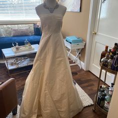 a wedding dress on display in a living room