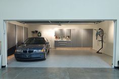 a car is parked in the garage with its door open