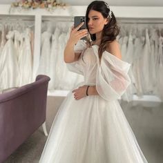 a woman is taking a selfie in her wedding dress