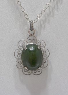 "Vintage olive green jade (new jade) pendant necklace. 15\" silver tone chain with a spring fastener. Sterling filigree frame holds an olive green prong set jade cabochon. Excellent condition." Silver Jade Cabochon Necklace, Silver Necklace With Jade Cabochon, Filigree Frame, Funky Necklace, Jade Pendant Necklace, Cabochon Necklace, Jade Pendant, Green Jade, Glass Bead Necklace