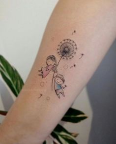 a girl holding a dandelion tattoo on her arm