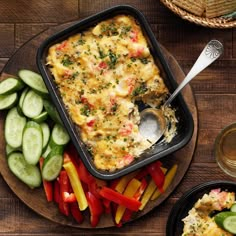 a casserole dish with vegetables on the side