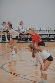 two volleyball players on the court during a game