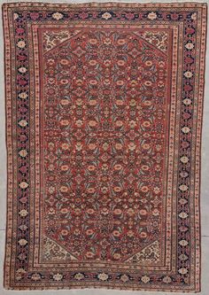 an antique persian rug with red, blue and black colors on the bottom half of it