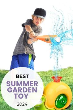 a young boy is playing with a toy in the grass and has water coming out of it