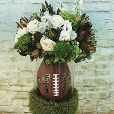 a vase filled with flowers and a football