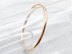 This can easily be worn alone but would look great stacked with other bracelets as well. The bangle is an oblong shape crafted of polished yellow 18-karat gold. This is such a simple design, and so pretty on the wrist!Metal: 18K Yellow GoldWidth: 4.0 mmInside Circumference: 7 Inches Modern Formal Bracelets With Simple Design, Minimalist Yellow Gold Hoop Bracelet, Modern Bangle Bracelet With Simple Design, Fine Jewelry Everyday Bangle Bracelet, Yellow Gold Bangle Bracelet For Everyday, Elegant Bangle With Simple Design, Minimalist Formal Bracelets With Open Band, Minimalist Gold Hoop Bracelet, Modern Simple Bangle Bracelet