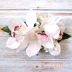 a bouquet of white flowers sitting on top of a wooden table