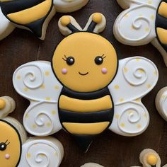 decorated cookies in the shape of bees on a table