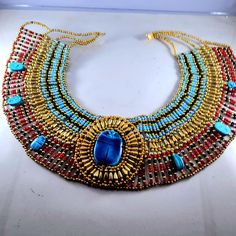 "his beautiful Hand Made Cleopatra Necklace. Made In Egypt . Type : homemade item . Style : Cleopatra Necklace. Brand : Domarket . Dimensions Materials: Multi Color Beads , Wire, Yarn And Clasp Size (Approx) :Size (Approx) : One size fits all around the neck:(49 cm)19.7\" - Width:(10.2 cm)4\" Weight:250 Gram. *There are different sizes and shapes suitable for girls and women from the same decade. Visit the rest of our store product * it was implemented by skilled egyptian artist *customer's sati Egyptian Inspired Jewelry, Cleopatra Necklace, Egyptian Party, Eye Of Horus Necklace, Egypt Jewelry, Ancient Egyptian Jewelry, Egyptian Fashion, Egyptian Necklace, Egyptian Inspired