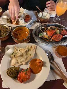 a table filled with different types of food and silver wares on top of it