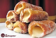 several pastries stacked on top of each other with powdered sugar and icing