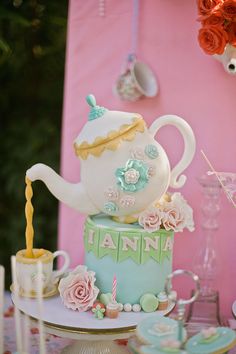 there is a teapot cake on the table