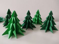 green paper christmas trees sitting on top of a table