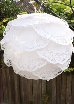 a white light hanging from a wooden fence