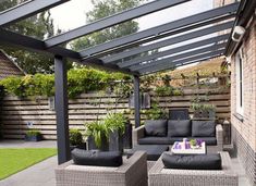 an outdoor patio with wicker furniture and potted plants