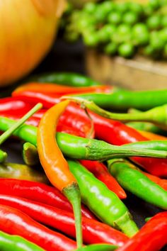 peppers and other vegetables on display at a market