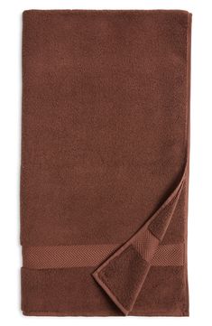 a brown towel folded on top of a white table