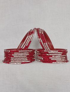 Bangles Name - Penali ten+ten   Color -red   Size - 2.2/2.4/2.6/2.8   Weight - 60 grams   Piece - 12   Stone Color- white and red  100% Glass Bangles & Handmade Product. You can wear it while going to a wedding by matching it with your clothes. You can also gift it to someone. You can also wear it in an engagement. It looks very beautiful in your hands. about shipping  Ships within 1 to 3 business days after payment is received  We ship orders every day except Sundays and holidays  When your ord Plastic Round Jewelry For Parties, Round Plastic Party Jewelry, Red Plastic Party Jewelry, Red Round Bangle For Party, White Stone Bangles, Stone Bangles, Ten Ten, 12 Stones, Glass Bangles