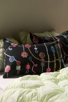 two black pillows sitting on top of a bed