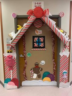 a door decorated with candy canes and decorations