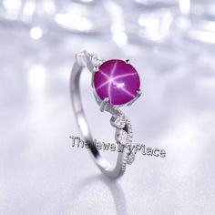 This Ring Features a 7X7 MM Round Cabochon Natural Lindy Star and Sterling Silver Finished with rhodium. Customization is available. It is made by hand, and it will take about 3 to 5 business days to finish the ring after your payment is completed. Product Details Main Stone: Natural Pink Lindy Star Metal Type: 92.5 Sterling Silver finished with rhodium Accent stone : Zircon How To take care of This Ring - Keep the jewelry away from direct heat, water, perfumes, deodorants, and other strong chem Silver Star-shaped Crystal Ring Gift, Silver Star-shaped Crystal Ring For Anniversary, Silver Star-shaped Crystal Promise Ring, Star Sapphire Ring, Ring Ruby, Star Sapphire, Star Ruby, Star Ring, Ring Promise