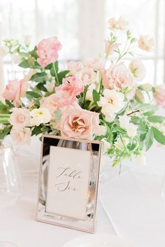 there is a vase with flowers in it and a sign on the table that says mr and mrs