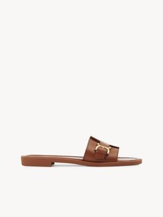 Chloé Marcie Slide | Chloé US Classic Slip-on Mules With Buckle Closure, Classic Brown Flat Slides, Classic Leather Slides For Spring, Summer Leather Slides With Gold Buckle, Classic Leather Sandals For Work, Classic Slip-on Sandals With Tang Buckle, Leather Open Toe Slides With Gold Buckle, Classic Leather Slides, Classic Flat Slides With Removable Insole